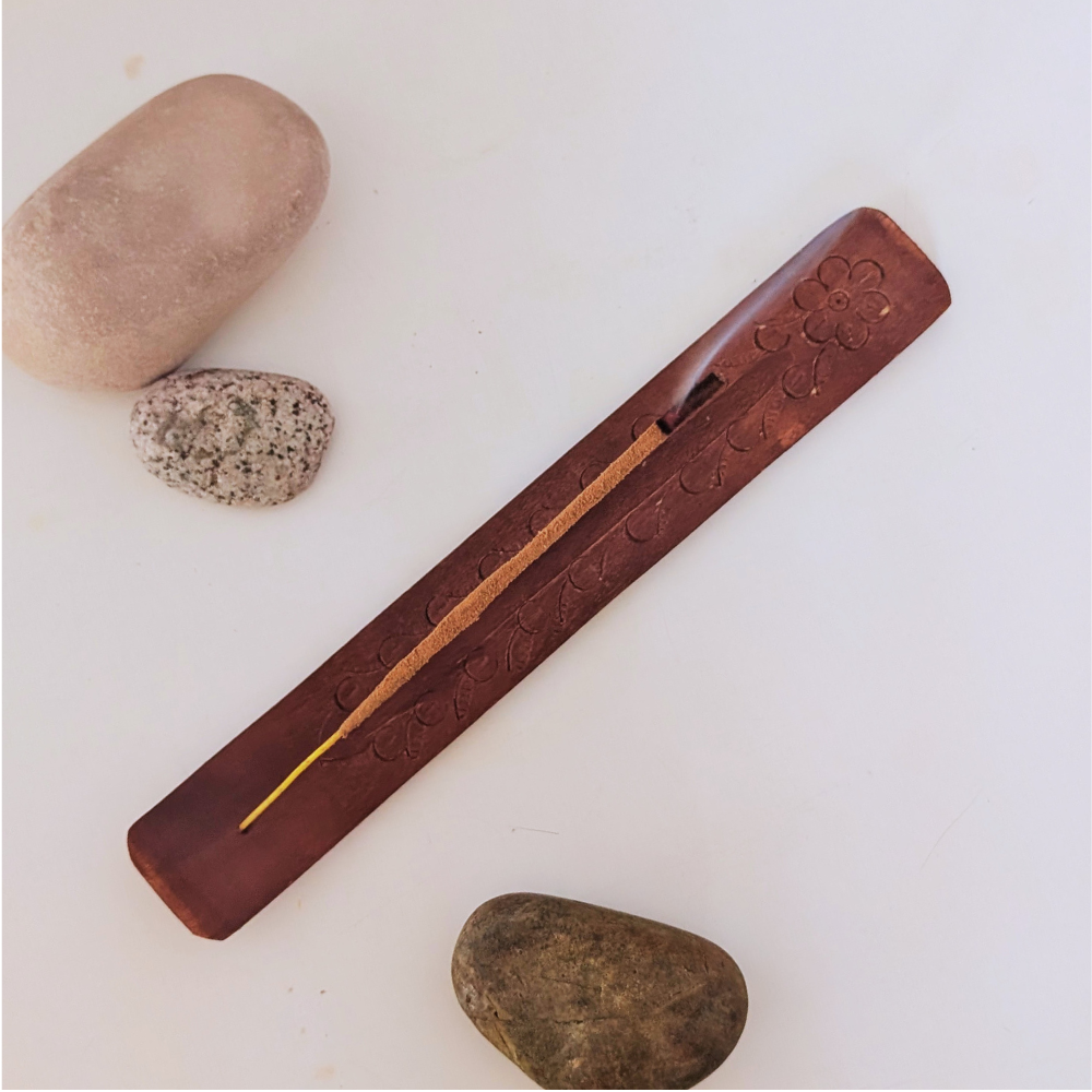 burning incense on a hand-crafted wood incense holder burner