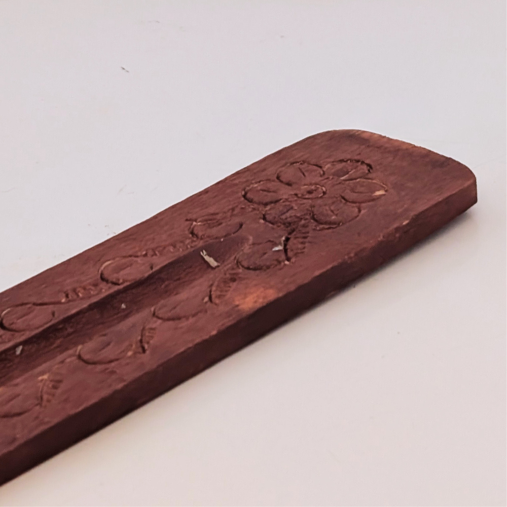 detail of floral hand-crafted wood incense holder burner