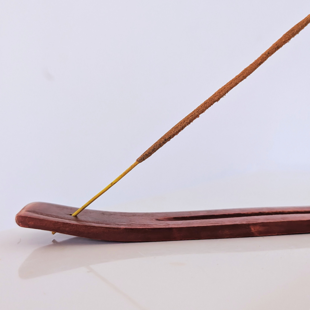hand-crafted wooden INCENse holder burner close up hole for incense sticks