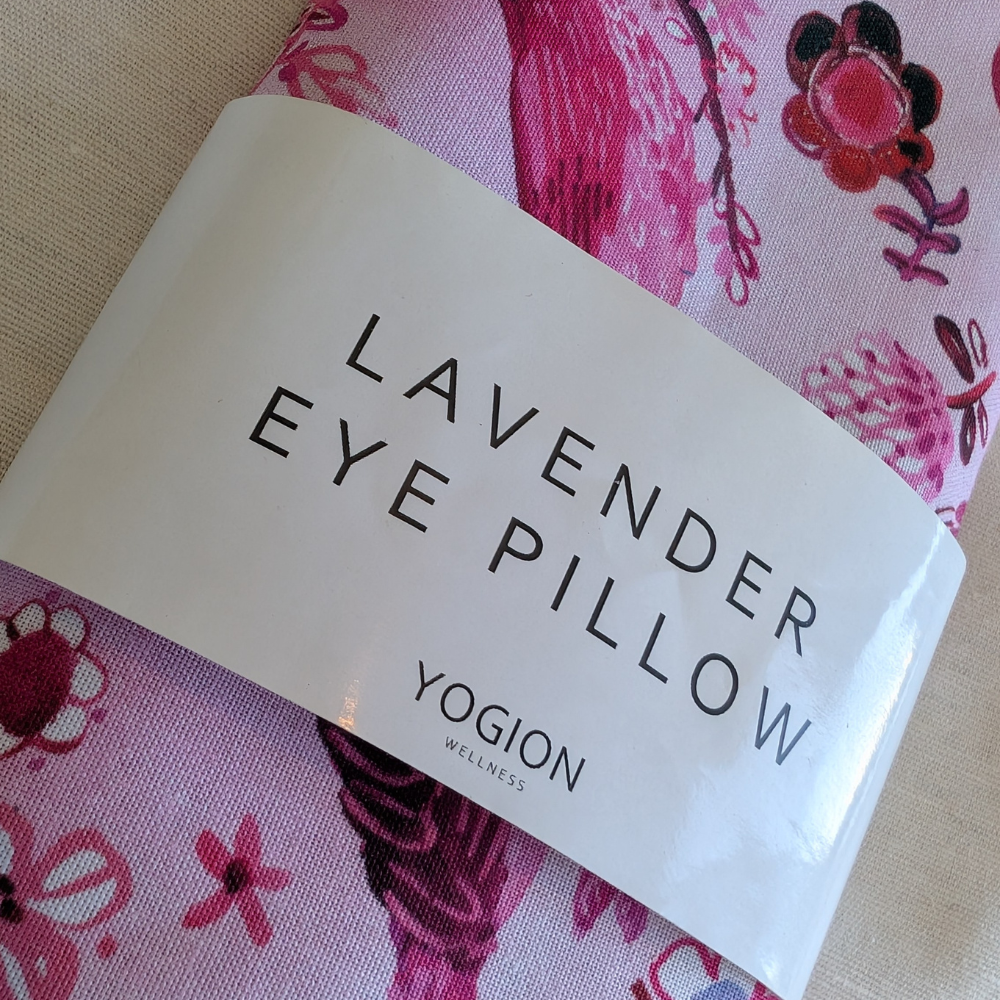 Lavender eye pillow packaging with 'Yogion' branding on a floral background