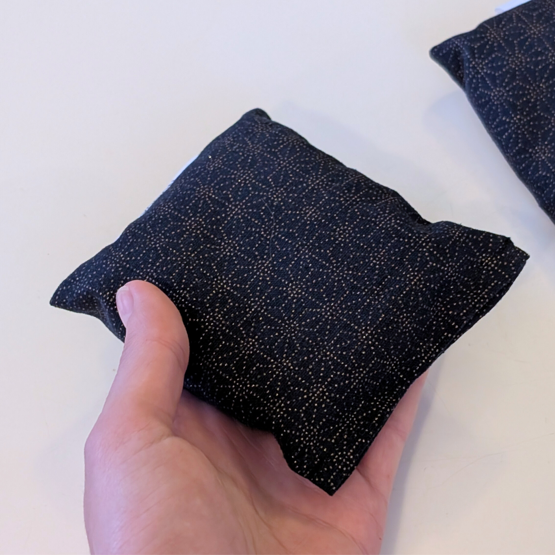 holding Lavender sachet black and gold geometric