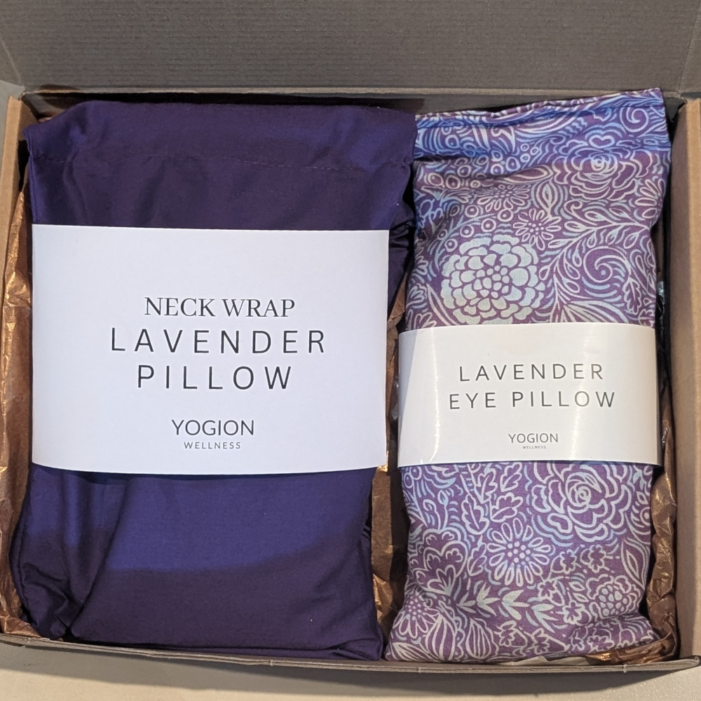 Two lavender products, a neck wrap and an eye pillow, in a box with YOGION branding.