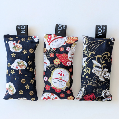 Three black japanese themed fabric lavender sachet bags on a white background by yogion wellness