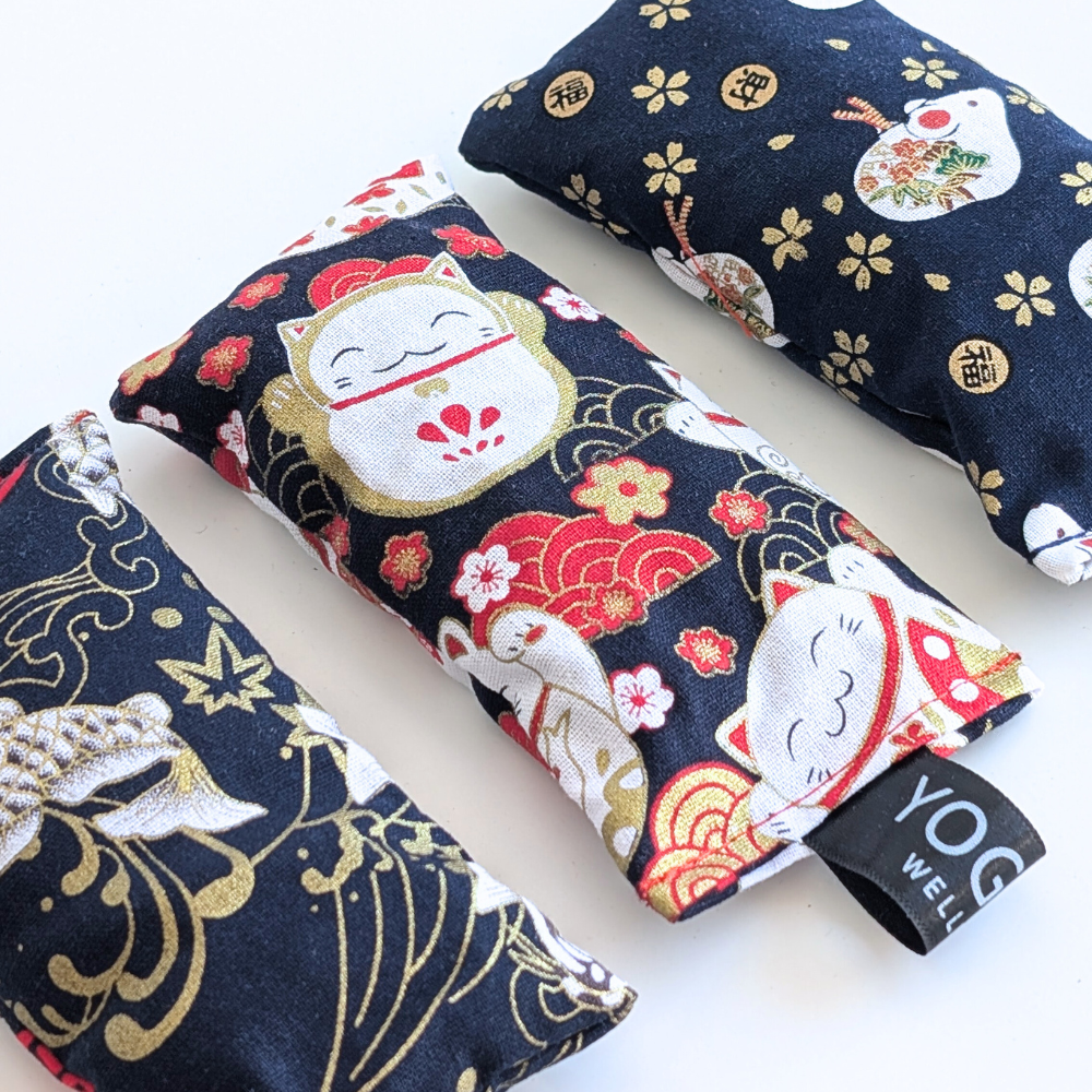 Three black japanese themed fabric lavender sachet bags on a white background by yogion wellness