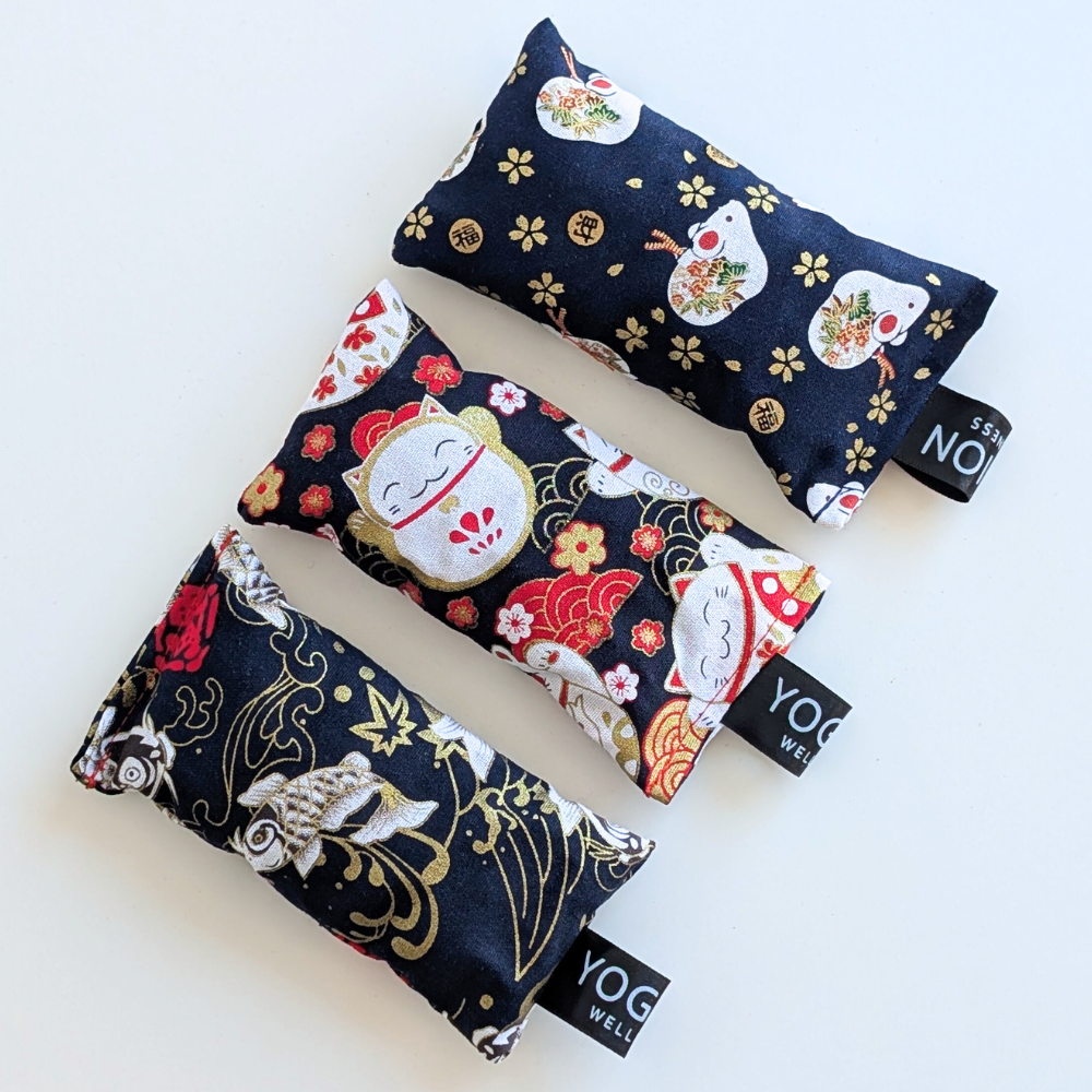 Three black japanese themed fabric lavender sachet bags on a white background by yogion wellness