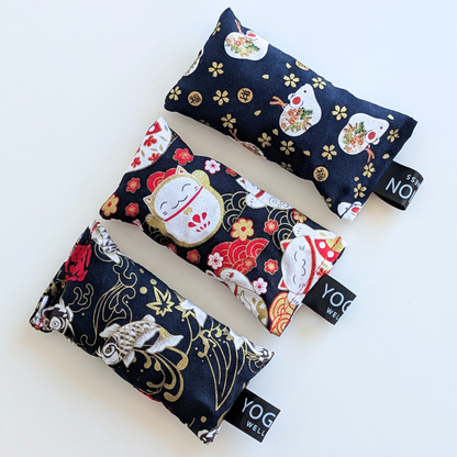 Three black japanese themed fabric lavender sachet bags on a white background by yogion wellness