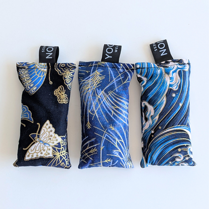 Three blue japanese themed fabric lavender sachet bags on a white background by yogion wellness
