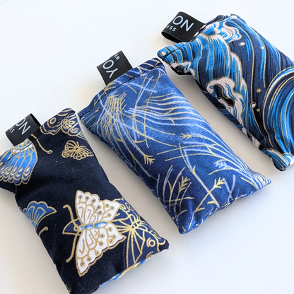 Three blue japanese themed fabric lavender sachet bags on a white background by yogion wellness