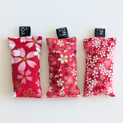 Three pink and gold patterned LAVENDER sachets on a white background by yogion wellness