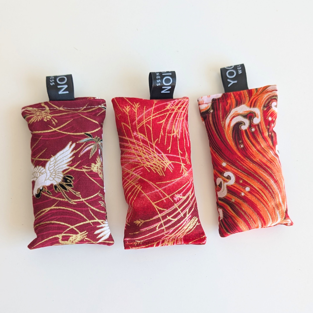 Red and gold patterned LAVENDER sachets on a white background by yogion wellness