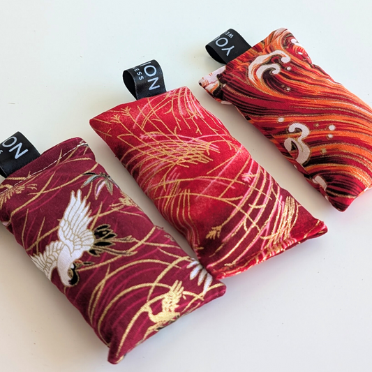 Red and gold patterned LAVENDER sachets on a white background by yogion wellness