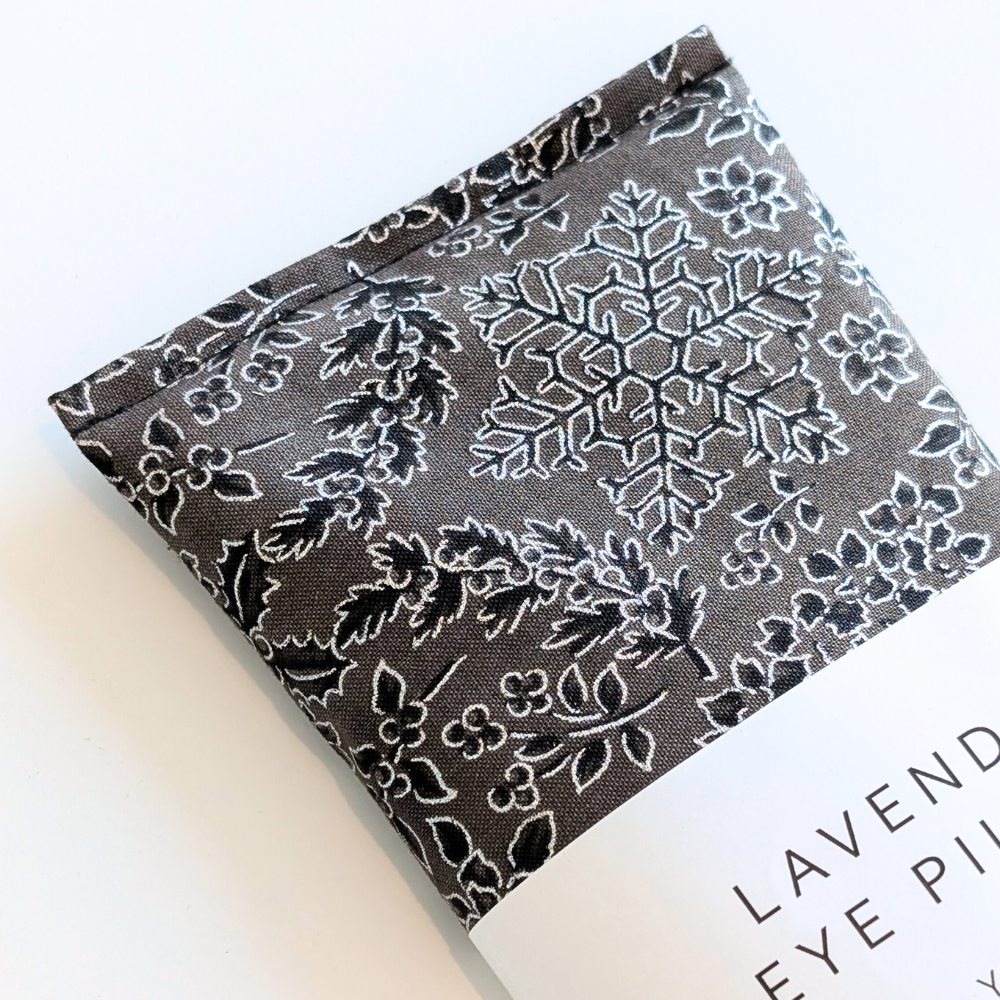Lavender eye pillow with floral christmas pattern packaging on a white background