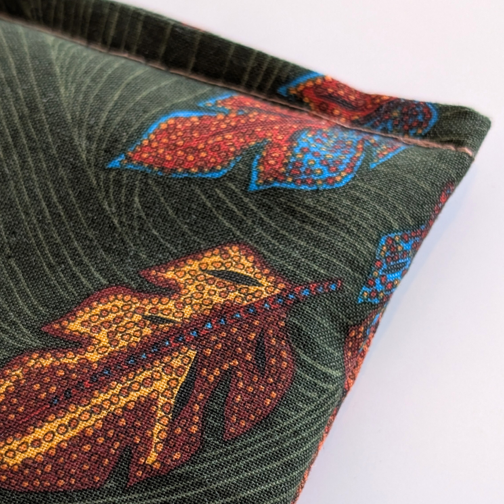 Close-up of a fabric with leaf pattern on a green background