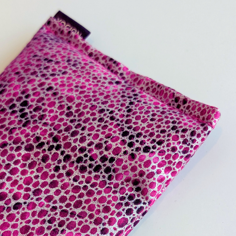 Pink and black polka dot fabric on a white background