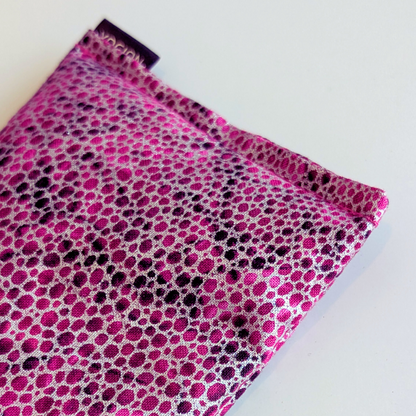 Pink and black polka dot fabric on a white background