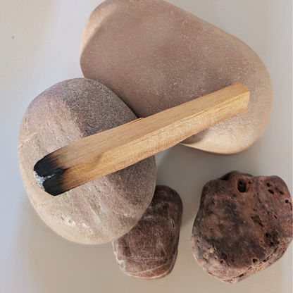 palo santo stick on rocks