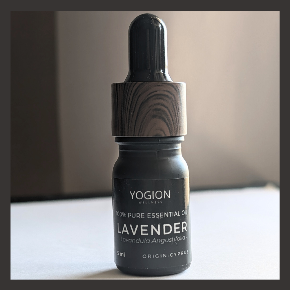 Yogion Wellness lavender essential oil bottle on a neutral background