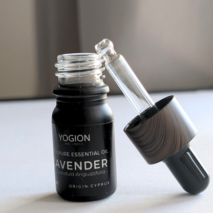 Yogion Wellness lavender essential oil bottle with dropper on a neutral background