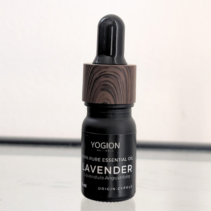 Yogion lavender essential oil bottle with wooden dropper on a white background