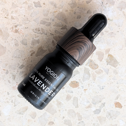 Yogion lavender essential oil bottle on a terazzo surface