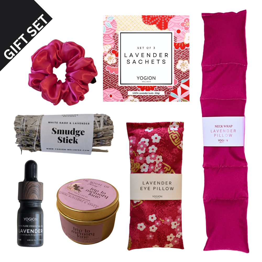 Gift set with lavender-themed products including a scrunchie, sachets,eye pillow, neck wraps, soy wax candle , sage stick, smudge stick, essential oil on a white background all handmade by yogion wellness