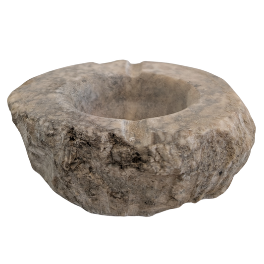 A rustic, hand-carved stone bowl with a rough, organic shape and a central recessed bowl, shown on a plain white background. for smudging and rituals