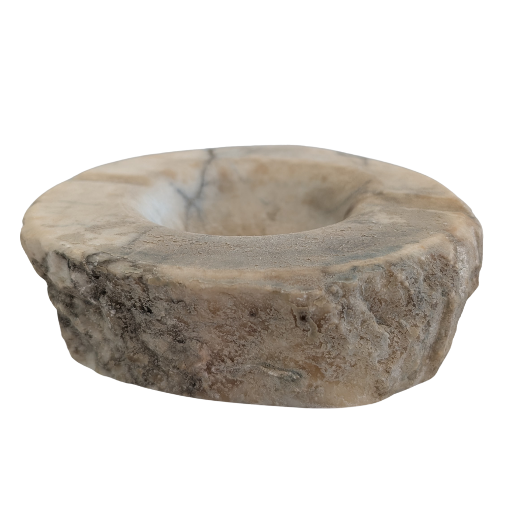 A circular stone candle holder or dish made of natural stone with a textured, rough outer edge and a smooth, recessed center, shown on a plain white background. for smudging and rituals