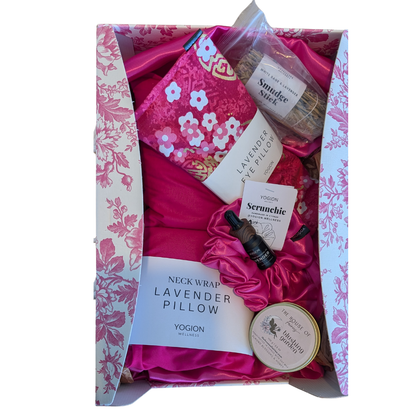 Gift set with lavender-themed products including a scrunchie, sachets,eye pillow, neck wraps, soy wax candle , sage stick, smudge stick, essential oil on a white background all handmade by yogion wellness