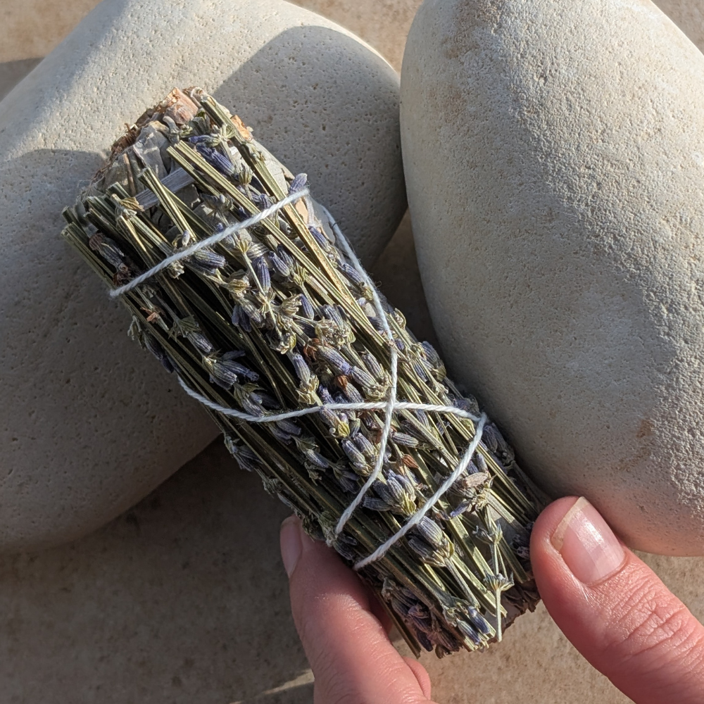 holding a Hand-tied white sage and lavender smudge stick for energy cleansing, spiritual rituals, and home purification, cyprus
