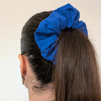 woman wearing blue scrunchie